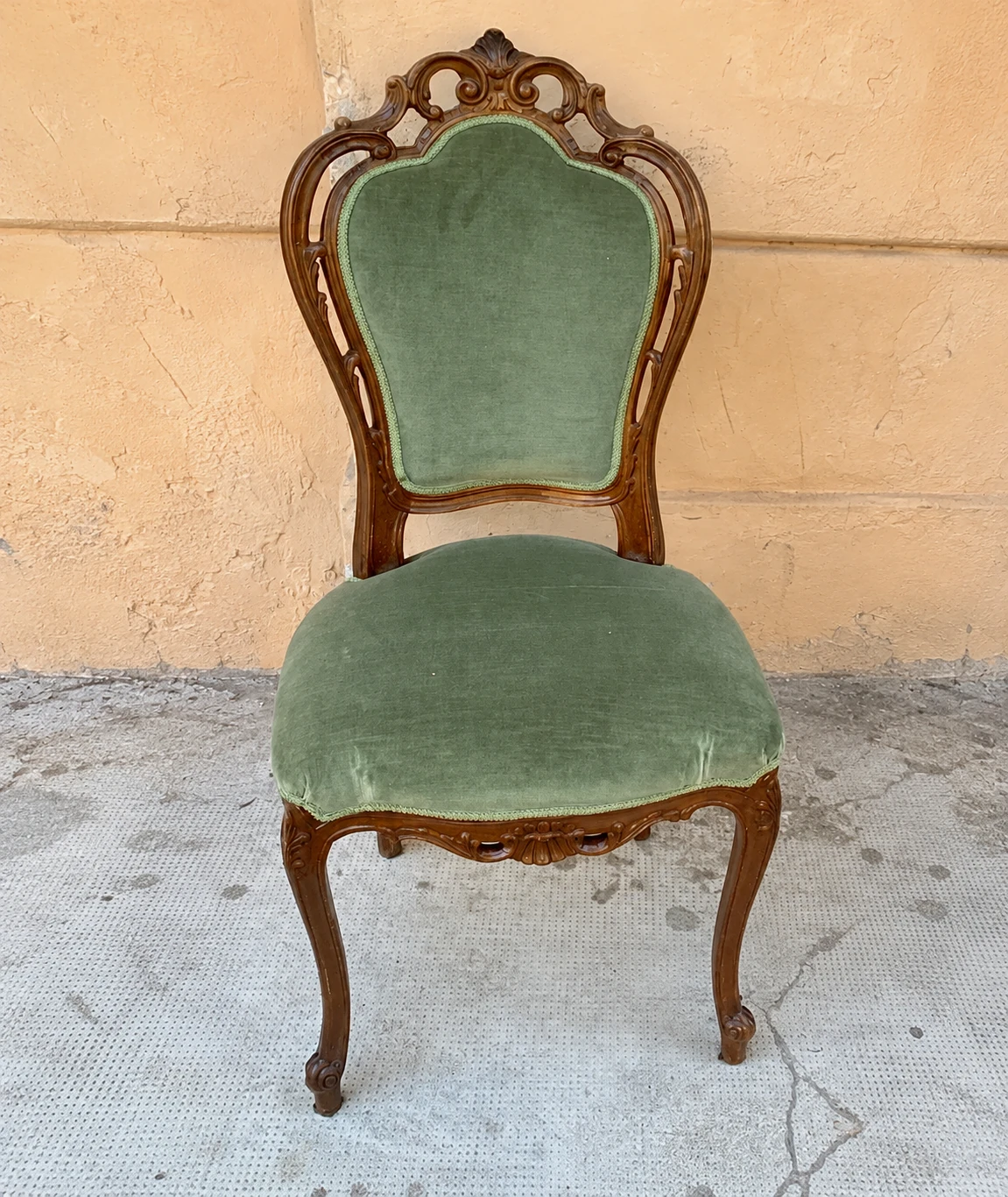Sedia in legno intagliato con il vecchio rivestimento verde, prima del rifacimento